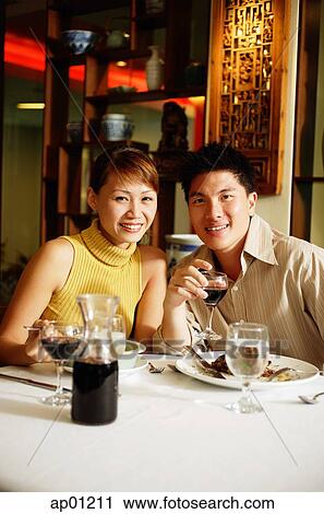 Couple having dinner in Chinese restaurant, smiling at camera View Large Photo Image Stock Image - Couple having dinner in Chinese restaurant, smiling at camera. Fotosearch