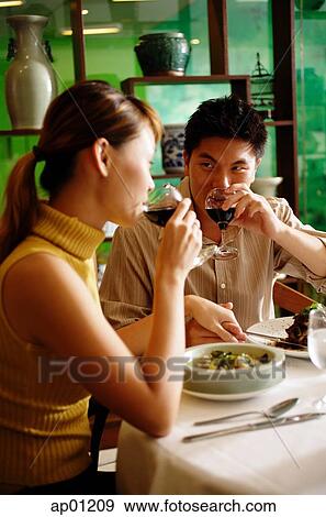 Couple in Chinese restaurant, drinking wine View Large Photo Image Stock Photo - Couple in Chinese restaurant, drinking wine. Fotosearch