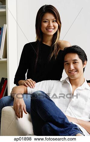 Couple in living room, portrait View Large Photo Image Stock Photo - Couple in living room, portrait. Fotosearch