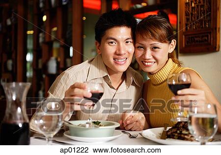 Couple in restaurant, smiling at camera View Large Photo Image Stock Image - Couple in restaurant, smiling at camera. Fotosearch