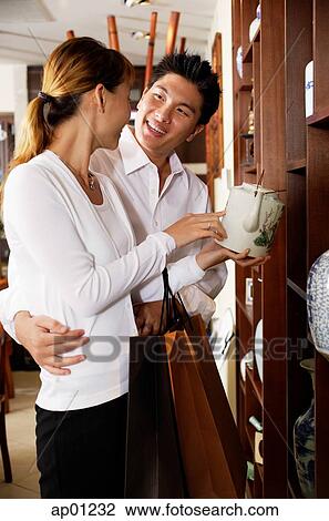 Couple looking at Chinese teapot in antique shop View Large Photo Image Stock Image - Couple looking at Chinese teapot in antique shop. Fotosearch