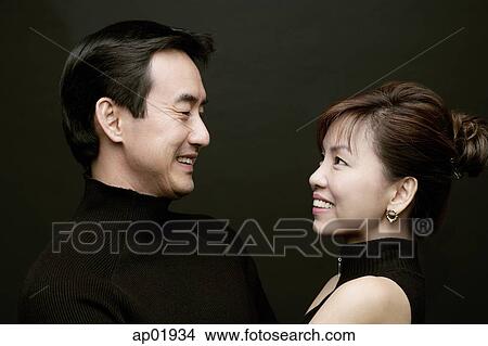 Couple looking at each other, face to face View Large Photo Image Picture - Couple looking at each other, face to face. Fotosearch