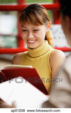 Stock Photo - Couple looking at menus. Fotosearch