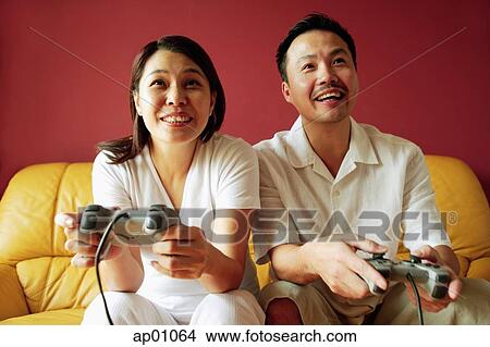 Couple playing video game View Large Photo Image Picture - Couple playing video game. Fotosearch