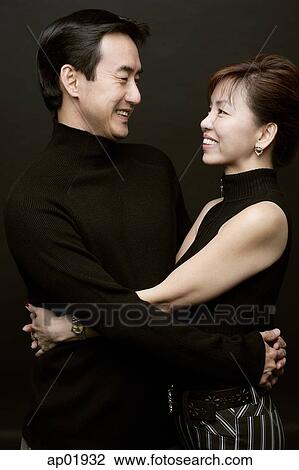 Couple with arms around each other View Large Photo Image Stock Image - Couple with arms around each other. Fotosearch