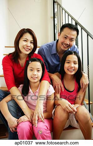 Family of four looking at camera, family portrait View Large Photo Image Stock Photo - Family of four looking at camera, family portrait. Fotosearch