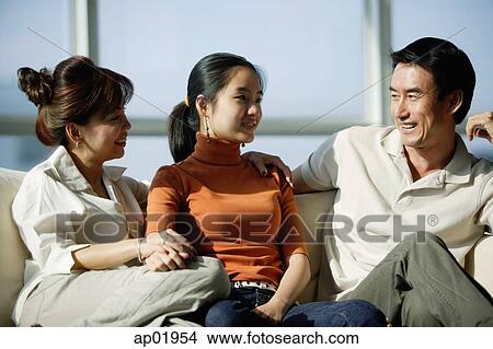 Family sitting on sofa View Large Photo Image Picture - Family sitting on sofa. Fotosearch