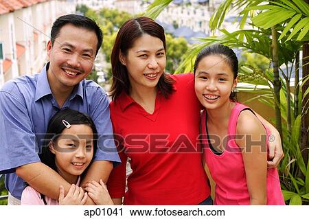 Family standing on balcony, smiling at camera, portrait View Large Photo Image Stock Image - Family standing on balcony, smiling at camera, portrait. Fotosearch