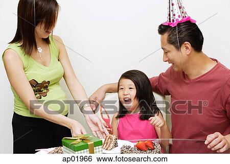 Stock Photograph - Family with one child celebrating a birthday. Fotosearch