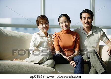 Family with one daughter sitting on sofa View Large Photo Image Stock Image - Family with one daughter sitting on sofa. Fotosearch