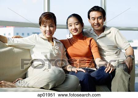 Family with one daughter sitting side by side on sofa View Large Photo Image Stock Image - Family with one daughter sitting side by side on sofa. Fotosearch