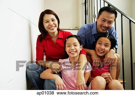 Family with two girls, smiling at camera View Large Photo Image Stock Photo - Family with two girls, smiling at camera. Fotosearch