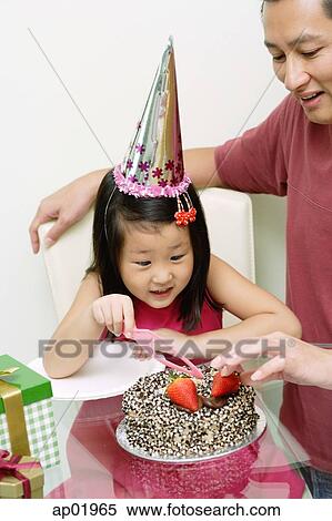 Father And Daughter In Front Of Birthday Cake Daughter Holding