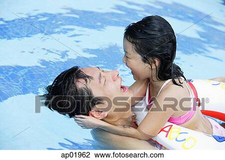 Father and daughter in swimming pool, daughter with float View Large Photo Image Stock Image - Father and daughter in swimming pool, daughter with float. Fotosearch