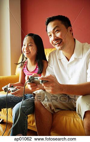 Father and daughter playing video games View Large Photo Image Stock Image - Father and daughter playing video games. Fotosearch