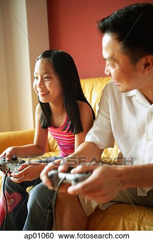 Father and daughter playing video games, father looking at daughter View Large Photo Image Stock Image - Father and daughter playing video games, father looking at daughter. Fotosearch