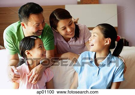 Father and mother with two daughters in bedroom View Large Photo Image Stock Image - Father and mother with two daughters in bedroom. Fotosearch