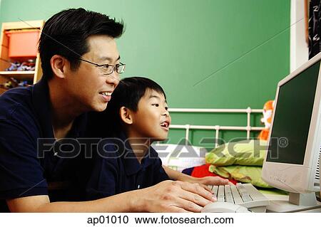 Father and son using computer View Large Photo Image Stock Image - Father and son using computer. Fotosearch