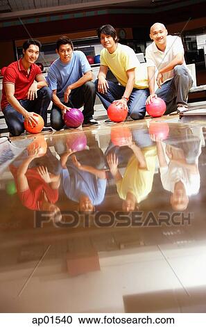 Four men in bowling alley, crouching, holding bowling balls View Large Photo Image Stock Image - Four men in bowling alley, crouching, holding bowling balls. Fotosearch