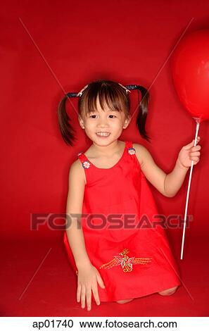 Girl holding heart shaped balloon, kneeling on floor View Large Photo Image Stock Image - Girl holding heart shaped balloon, kneeling on floor. Fotosearch