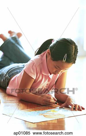 Girl lying on floor, drawing with crayons View Large Photo Image Stock Photography - Girl lying on floor, drawing with crayons. Fotosearch