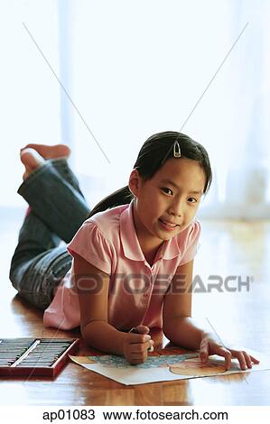Girl lying on floor, with paper and crayons, looking at camera View Large Photo Image Stock Image - Girl lying on floor, with paper and crayons, looking at camera. Fotosearch