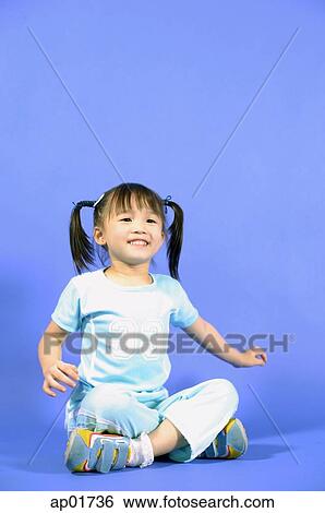 Girl sitting cross-legged, smiling View Large Photo Image Stock Photograph - Girl sitting cross-legged, smiling. Fotosearch