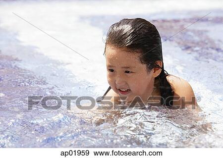 Stock Photo - Girl swimming in pool, head above water. Fotosearch