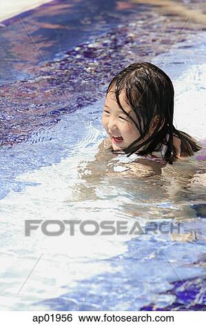 Girl swimming in pool View Large Photo Image Stock Photograph - Girl swimming in pool. Fotosearch