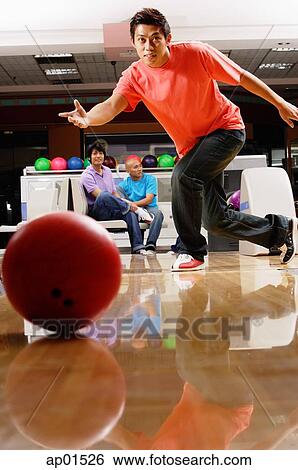 Man bowling, people sitting in the background View Large Photo Image Stock Photograph - Man bowling, people sitting in the background. Fotosearch