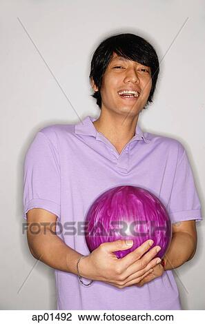 Man carrying bowling ball, looking at camera View Large Photo Image Stock Image - Man carrying bowling ball, looking at camera. Fotosearch