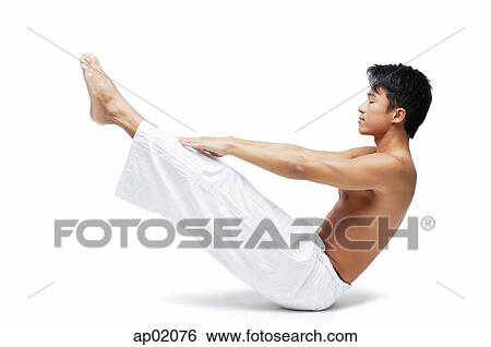 Man doing yoga, sitting on floor, raising leg View Large Photo Image Stock Photograph - Man doing yoga, sitting on floor, raising leg. Fotosearch