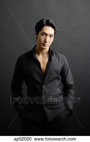 Man dressed in black, standing against black background, hands in pocket View Large Photo Image Stock Image - Man dressed in black, standing against black background, hands in pocket. Fotosearch