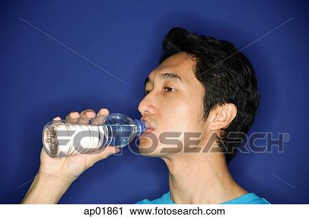 Man drinking water from bottle View Large Photo Image Stock Image - Man drinking water from bottle. Fotosearch