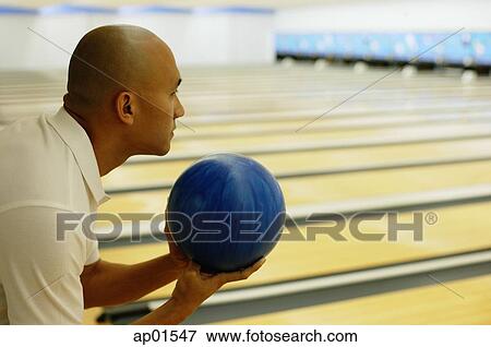 Man holding bowling ball, preparing to bowl View Large Photo Image Stock Photo - Man holding bowling ball, preparing to bowl. Fotosearch