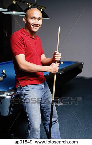 Man leaning against pool table, looking at camera View Large Photo Image Stock Photo - Man leaning against pool table, looking at camera. Fotosearch