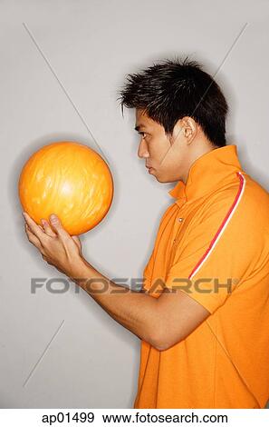 Man looking at bowling ball, side view View Large Photo Image Stock Photo - Man looking at bowling ball, side view. Fotosearch