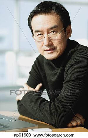Man looking at camera, arms crossed, portrait View Large Photo Image Stock Image - Man looking at camera, arms crossed, portrait. Fotosearch