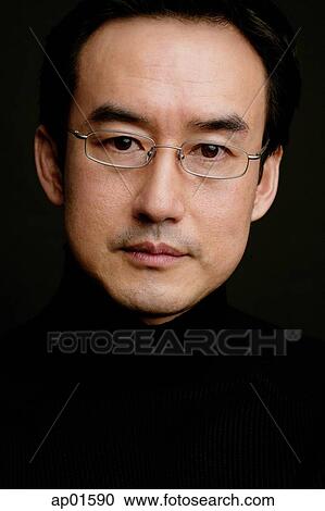 Man looking at camera, head shot, black background View Large Photo Image Stock Image - Man looking at camera, head shot, black background. Fotosearch