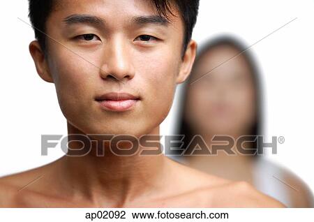 Man looking at camera, person in the background View Large Photo Image Stock Image - Man looking at camera, person in the background. Fotosearch