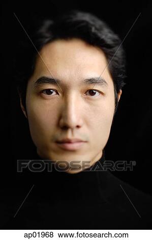 Stock Photo - Man looking at camera, portrait. Fotosearch