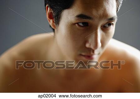 Picture - Man looking away, semi-dressed, portrait. Fotosearch