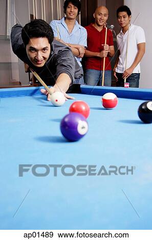 Man playing pool, other men watching in the background View Large Photo Image Stock Photo - Man playing pool, other men watching in the background. Fotosearch