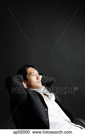 Man sitting, leaning back, hands on head View Large Photo Image Stock Image - Man sitting, leaning back, hands on head. Fotosearch