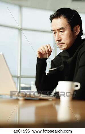 Man using laptop View Large Photo Image Stock Photograph - Man using laptop. Fotosearch