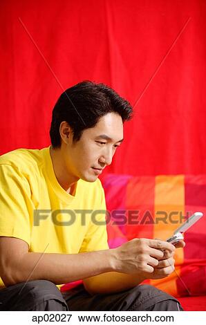 Man using mobile phone, text messaging View Large Photo Image Stock Photo - Man using mobile phone, text messaging. Fotosearch