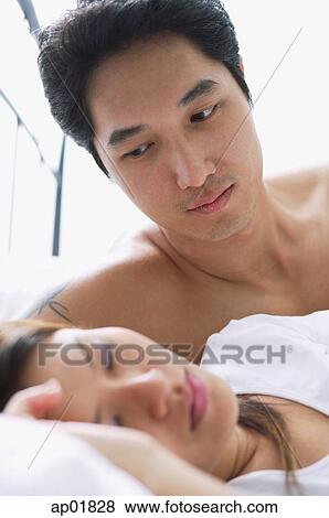 Stock Photo - Man watching woman sleep. Fotosearch