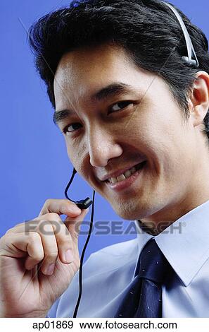 Man wearing headset, looking at camera, smiling View Large Photo Image Stock Photo - Man wearing headset, looking at camera, smiling. Fotosearch