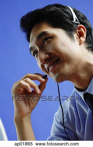 Stock Photography - Man wearing headset. Fotosearch
