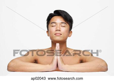 Man with eyes closed, hands together View Large Photo Image Stock Image - Man with eyes closed, hands together. Fotosearch